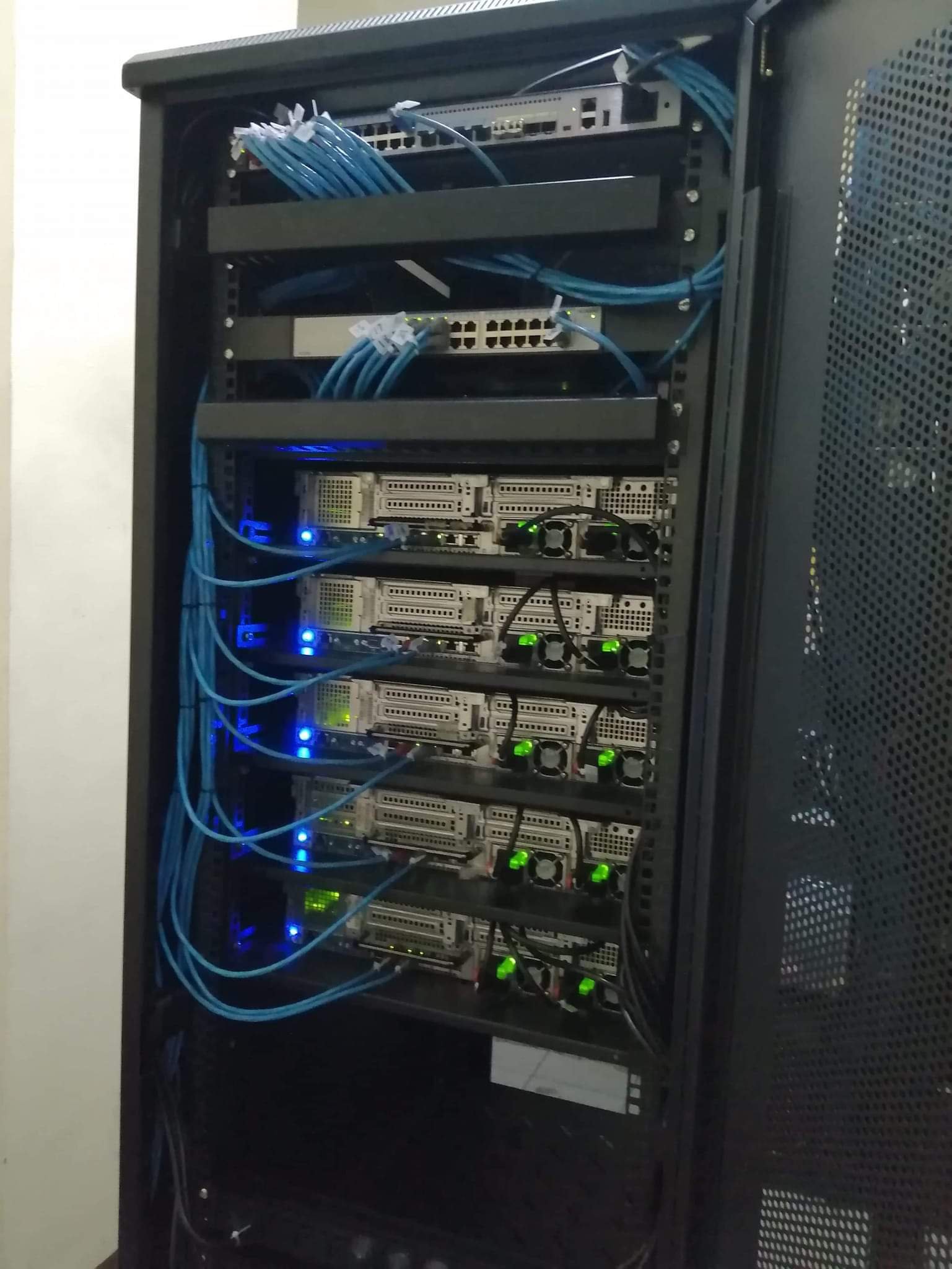Server cabinet with connected computer equipment and blue cables